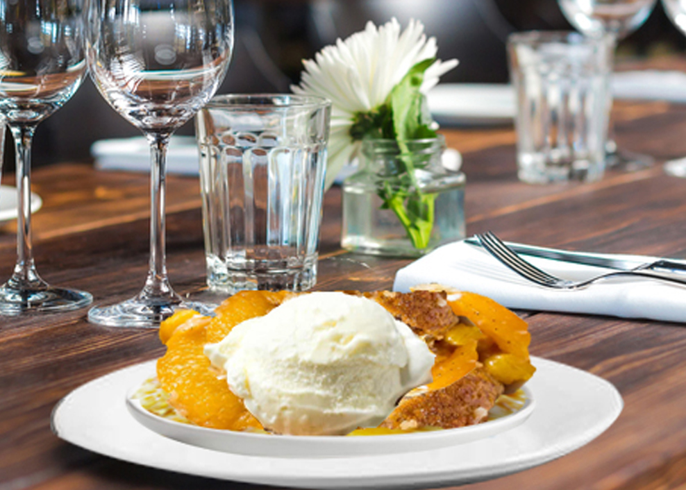 A white plate topped with fruit and ice cream.