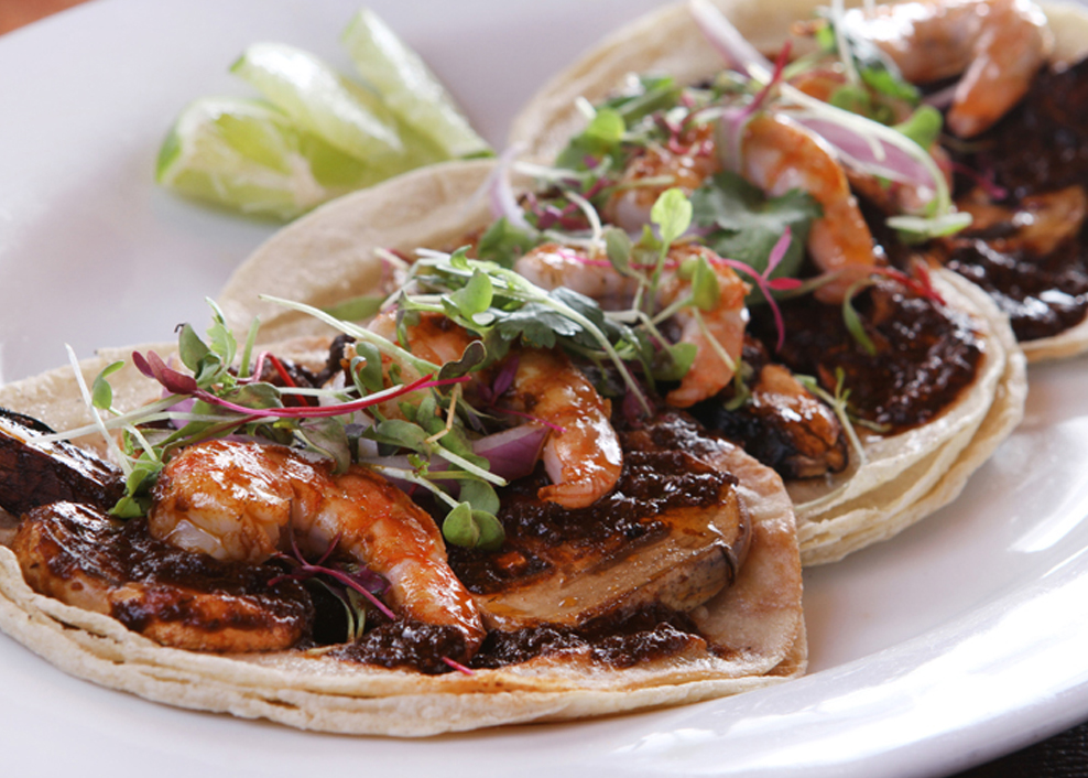 A plate of food with two tortillas and some vegetables.