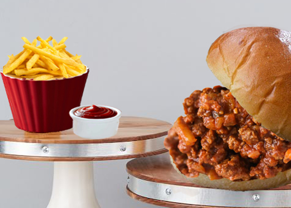 A sandwich and fries on a table with ketchup.