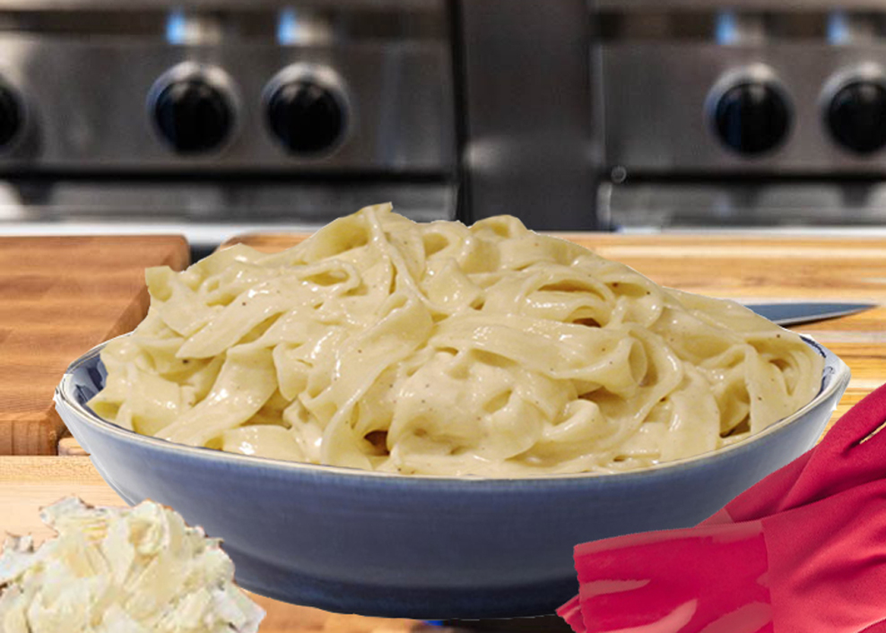 A bowl of noodles with cheese on top.