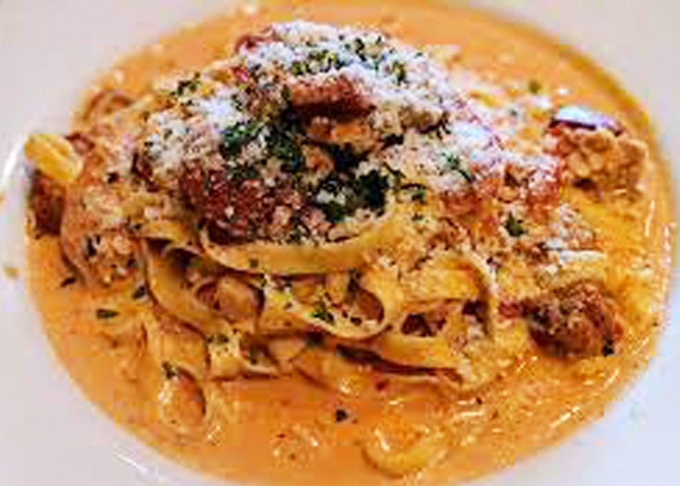 A plate of pasta with meat and cheese.