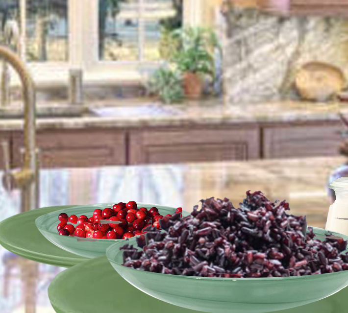 Two bowls of food on a table in front of a window.