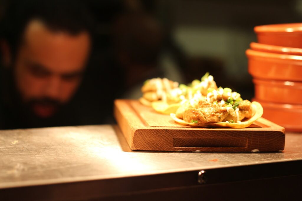 A man sitting at the table with two plates of food.