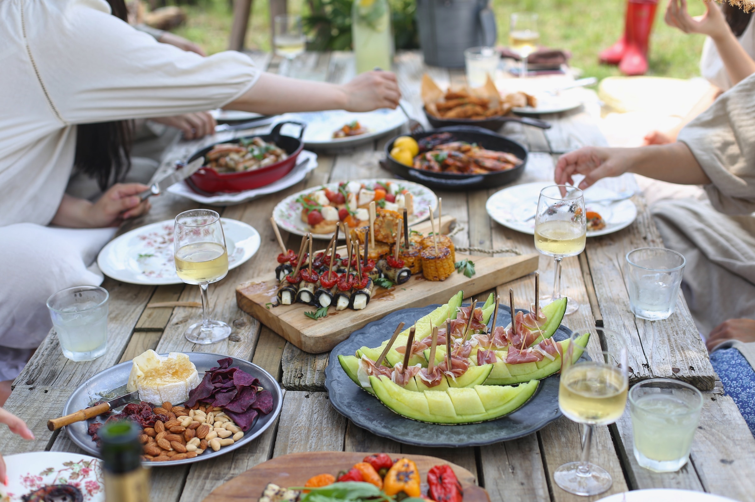 A table filled with plates of food and wine.