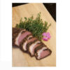 A piece of meat on top of a cutting board.