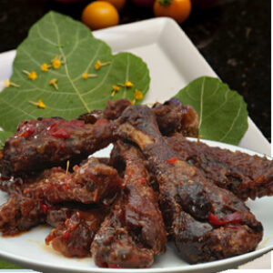 A plate of food with meat and leaves on the side.